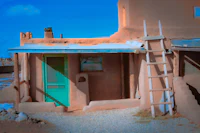 an adobe building with a green door